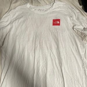 The North Face white tee with red logo. Worn on a Disney trip. Good condition.